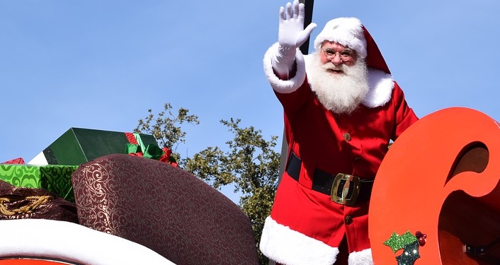 Image of Santa in a sleigh waving in the annual St. Augustine Christmas Parade 2021