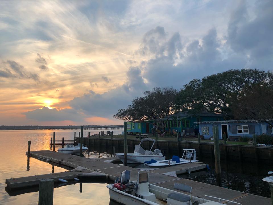 Image contains the outdoors, a store, boats, and water.