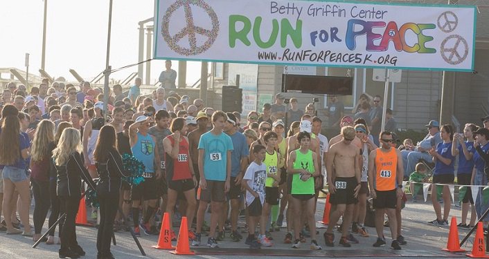 Runners, young & old, men & women, at the pier waiitng for start of the Betty Griffin Center Run For Peace 5K