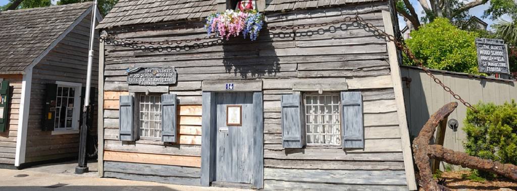 Image contains outdoors and the front entrance to the Oldest Wooden School House.