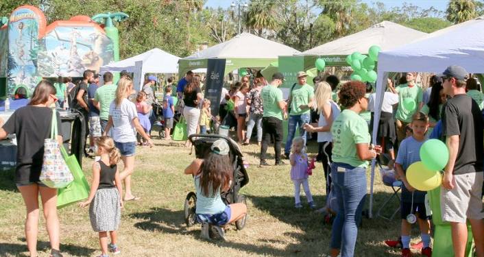 image of kids and parents by several booths outdoors at Ancient City Kids Day