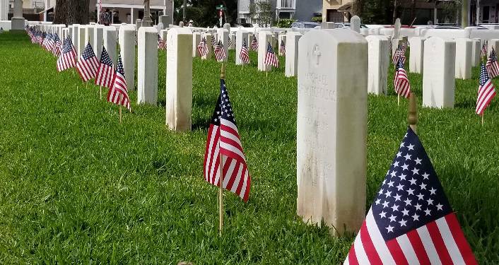 flags on graves for St. Augustine Memorial Day Observance
