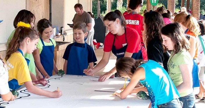 image of many kids participating in drawing event at FOSAA Children's Arts Festival