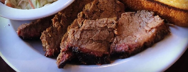 Image contains brisket on a plate.