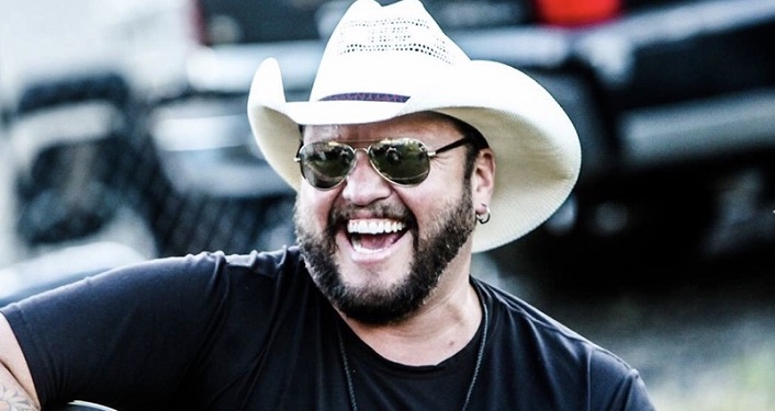 image of man with beard, wearing sunglasses, white cowboy hat, and black t-shirt; Independent country recording artist, Cliff Cody