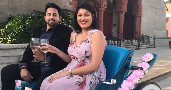 Couple sitting in carriage, toasting each other with glass of wine