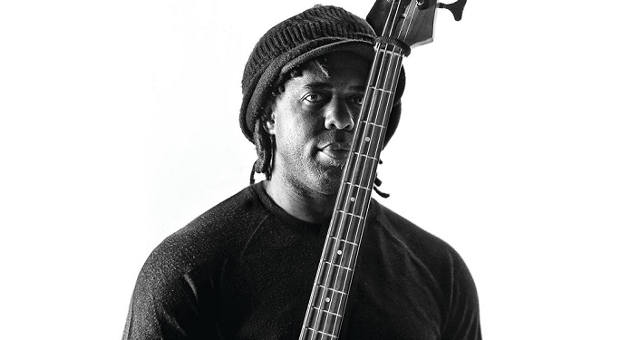 Victor Wooten, member of Bass Extemes, holding his bass guitar